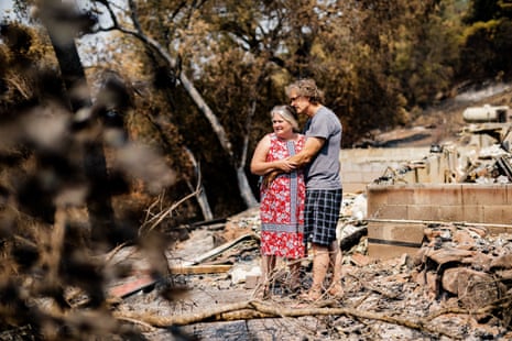 Jim and Leonore Wilson embrace next to the remnants of their house, on 29 August 2020, in Napa.