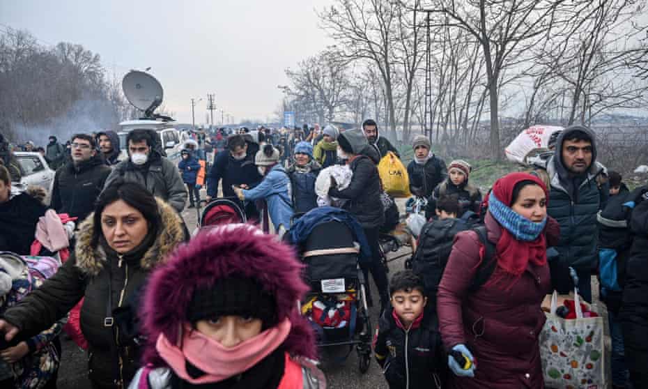 Migrants run toward the buffer zone on the Turkey-Greece border at Pazarkule, 29 February 2020. 