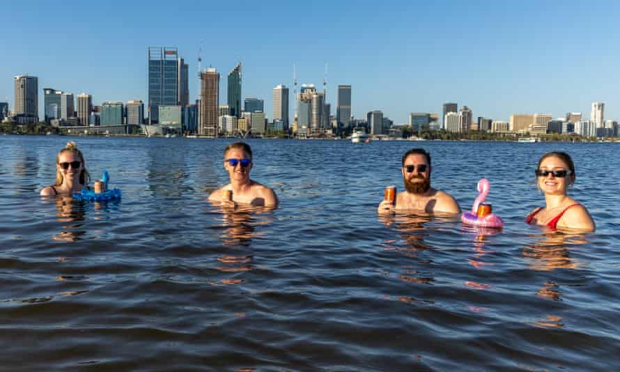 Locals cool off with a drink in Perth’s Swan River on Saturday as the city bakes in 41.1C heat.