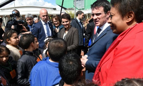 French Prime minister Manuel Valls (2nd R) talks with children next to Education minister Najat Vallaud-Belkacem and Minister of State for Cities, Youth and Sports, Helene Geoffroy. Asked whether headscarves should be banned by law from universities, Valls replied: ‘It should be done.’