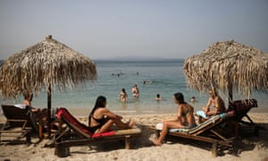 People enjoy the sun in Athens as beaches in Greece are officially reopened to the public following the easing of measures against the spread of coronavirus.