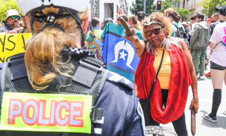 Elder Carly Rose confronts a police officer as during an Invasion Day rally in Brisbane.