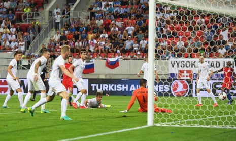 Adam Lallana of England shoots past goalkeeper Matus Kozacik to score the winning goal