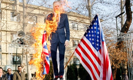 Iranian hardliners burn a cutout poster depicting British ambassador to Iran Robert Macaire along with during a memorial for passengers of Ukraine airplane in Tehran.