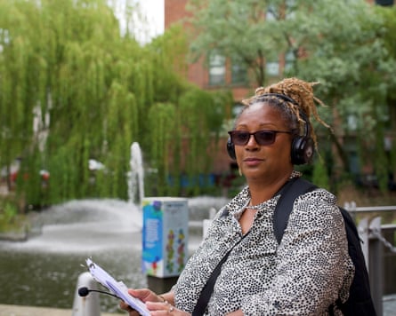 Saleh stands outdoors in front of a water fountain surrounded by green willow trees