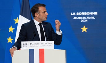 Emmanuel Macron gestures as he stands behind a plinth during his speech