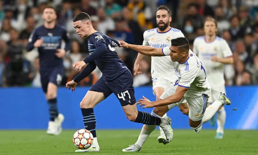 Phil Foden of Manchester City is hauled back by Casemiro of Real Madrid.