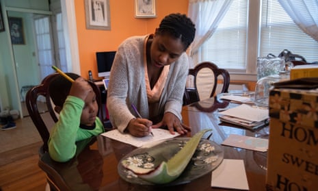 Geri Andre-Major helps her son Max, 5, with his school work in Mount Vernon, New York. Andre-Major said she was furloughed as a preschool teacher and her husband was laid off as a chef consultant. 
