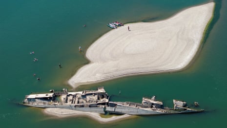People swimming near a sunken German warship