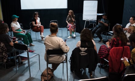 A group of people sat on chairs in a circle