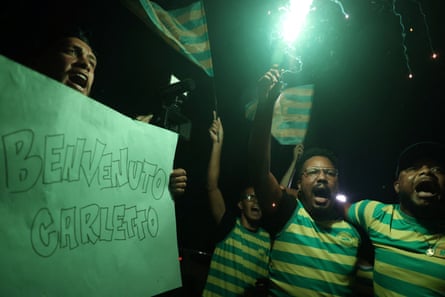Fans shout while displaying a welcome sign as they wait for the arrival of Brazil’s new national team coach Carlo Ancelotti outside a hotel in Rio de Janeiro