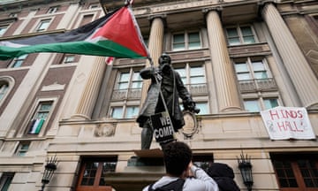 A student protester waves a Palestinian flag outside Hamilton Hall on the campus of Columbia University on 30 April 2024.
