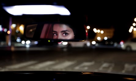 Hessah al-Ajaji drives her car down the capital’s busy Tahlia Street after midnight for the first time, in Riyadh, Saudi Arabia.