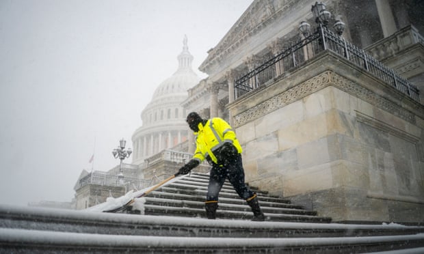 Snow falls over the US Capitol building on Monday.