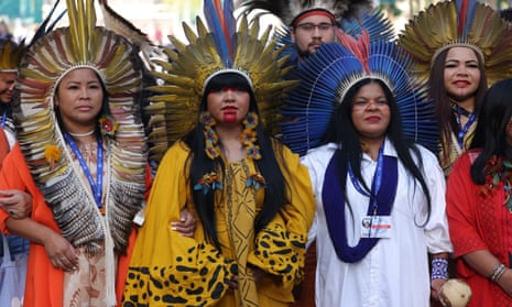 Representatives of indigenous groups from Brazil march through the conference venue on day six.