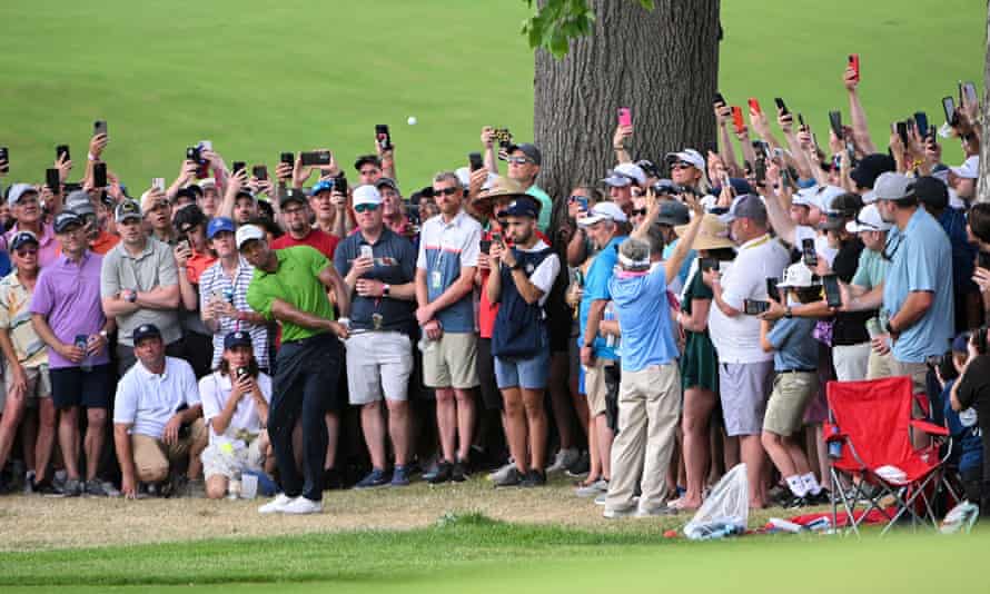 Tiger Woods plays his second shot from the 9th fairway during the second round