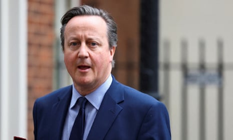 British Foreign Secretary David Cameron walks at Downing Street in London.