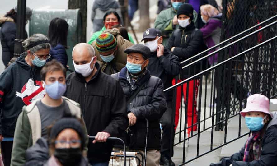 People wait on Dec. 11 at the St Clements Food Pantry for food in New York.