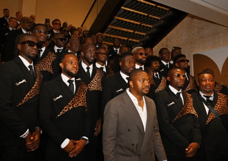 Men standing together, wearing leopard-print suits.