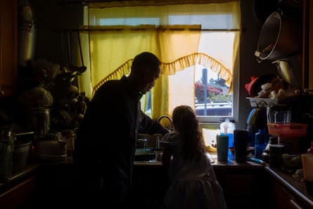 Silhouette of man and girls washing dishes