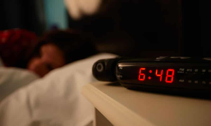 alarm clock early morning with early twenties woman lying in bed in a bedroom. Image shot 2016. Exact date unknown.D6A4N1 alarm clock early morning with early twenties woman lying in bed in a bedroom. Image shot 2016. Exact date unknown.