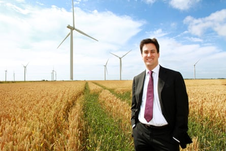 Ed Miliband stood in a field with wind turbines behind him