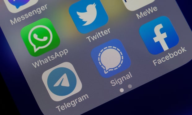 A smartphone showing the logos for WhatsApp, Facebook, Twitter, Telegram and Signal