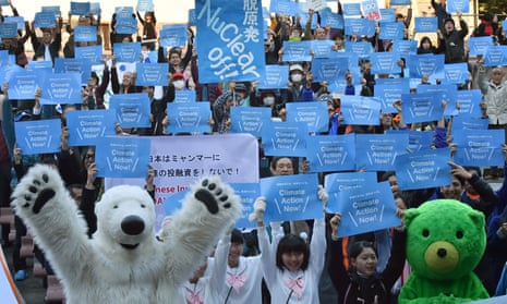 Environmentalists hold up placards that read “Climate Action Now!” during a rally in Tokyo on Saturday.
