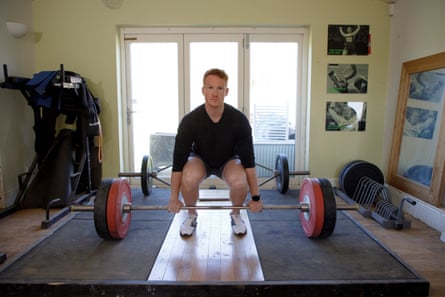 Greg Rutherford lifting weights in his house during training earlier this year.