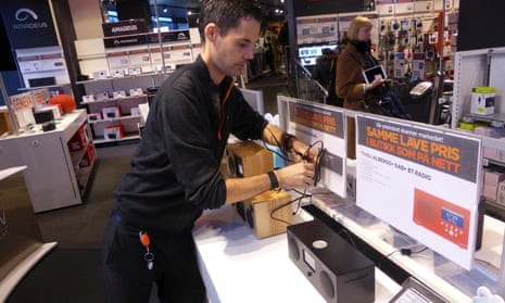 A worker arranges digital radios in an electronics shop in Oslo