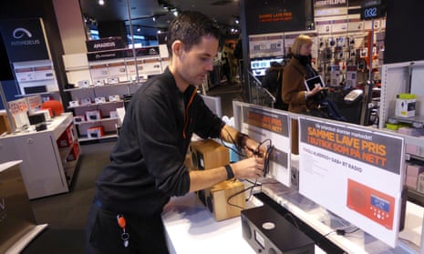A worker displays digital radios at an electronics outlet in Oslo