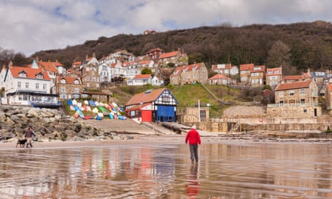 ‘A jumble of red-roofed cottages opening out on to a wide stretch of beach:’ Runswick Bay, North Yorkshire.