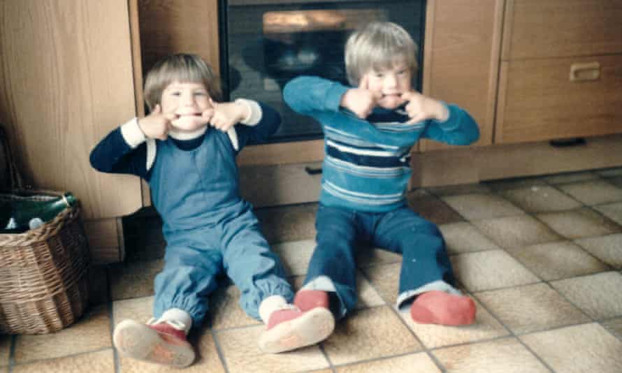 Dunja Batarilo and her brother David, aged four and six, in 1984 in their favourite spot: in front of the oven where their mother would make them hot chocolate.