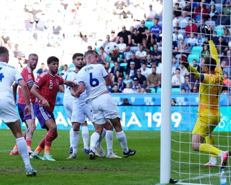 Scotland's Oli McBurnie (second left) heads towards goal against Slovenia.