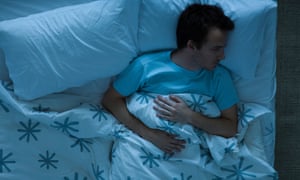 Man lying awake in bed