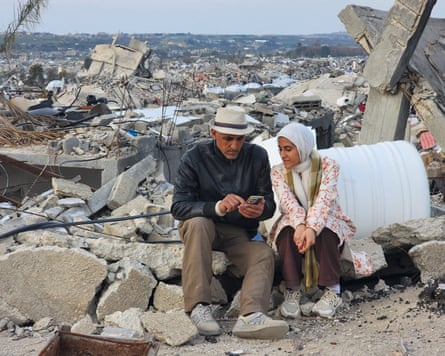 Tantesh and her father sitting on rubble