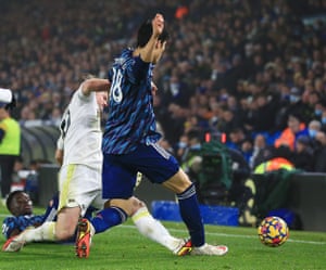 Joe Gelhardt of Leeds United is shown a yellow card for this challenge on Takehiro Tomiyasu of Arsenal.