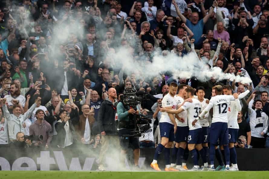Tottenham v Arsenal: Premier League – live! | Premier League 9 Spurs fans cheer their team as Emerson holds up a white flare thrown on by fans after Harry Kane opened the scoring.