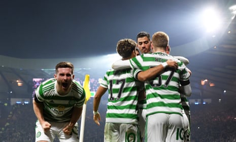 James Forrest (obscured) is surrounded by his Celtic teammates after scoring the breakthrough goal.