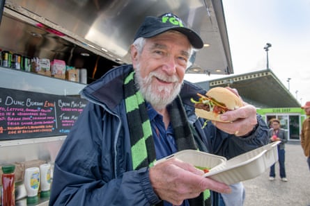 John Fowles with a vegan burger at Forest Green Rovers fanzone, Aug 2024.