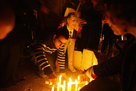 People light candles at a vigil
