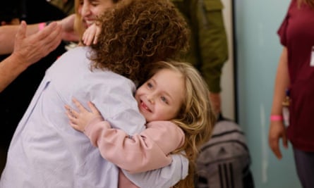 Emilia Aloni, five, is reunited with her family in an Israeli hospital on Saturday.