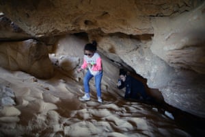 Tourists visit a cave at Maghrafa mountain near Bawiti in Bahariya oasis