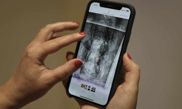 A mobile phone shows an image of an X-ray of Modigliani’s Nude with a Hat