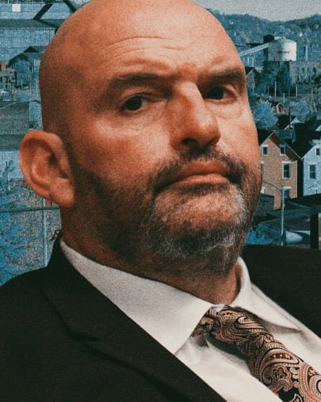 A scruffily bearded bald man in a suit.