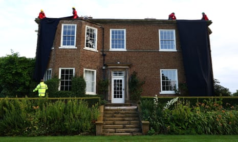 The house being covered in black fabric