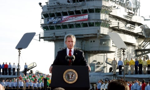 George W Bush in front of a navy warship
