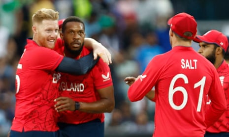 Chris Jordan of England (centre) is congratulated by. his team-mates after taking the wicket of Rohit Sharma of India.