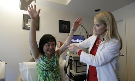 Doctor Jill Waibel examines Kim Phuc before the first of several laser treatments to reduce pain and the appearance of burn scars in her back and left arm.