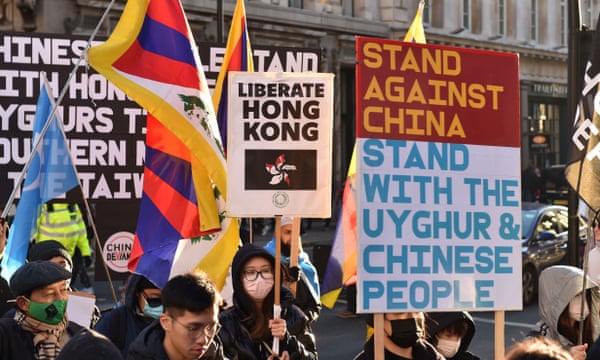 Opponents of the Chinese Communist party gather opposite Downing Street and march to the Chinese embassy in London.